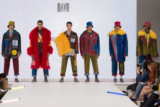 Male models standing on fashion catwalk