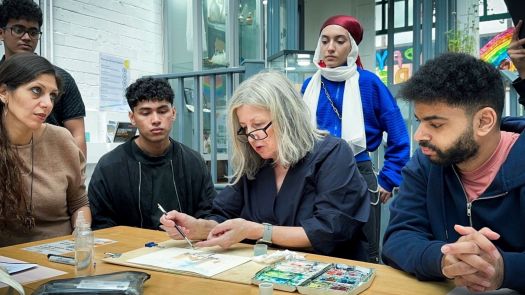 Teacher showing students how to paint 